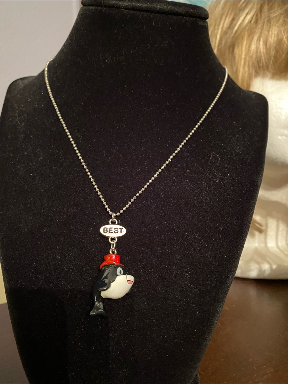 V! This necklace with orca (killer whale) pendant wearing a festive red hat